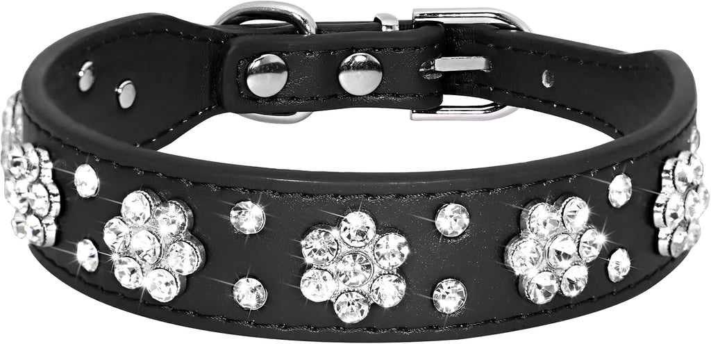 Close-up of a black PU leather dog collar with a studded rhinestone flower pattern and a metal D-ring.