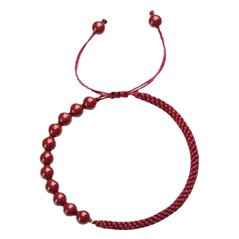 Braided rope bracelet with cinnabar beads in 8mm diameter and wine red colour