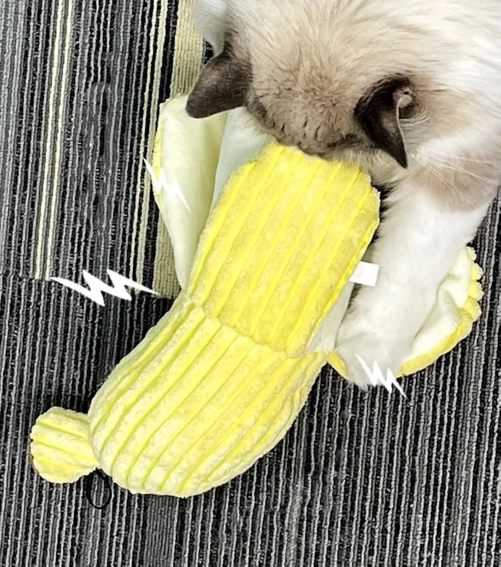Yellow banana-shaped plush cat toy with crinkle sound, shown next to a cat for scale.