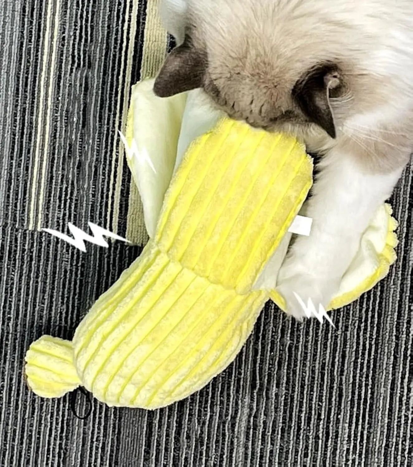 Yellow banana-shaped plush cat toy with crinkle sound, shown next to a cat for scale.