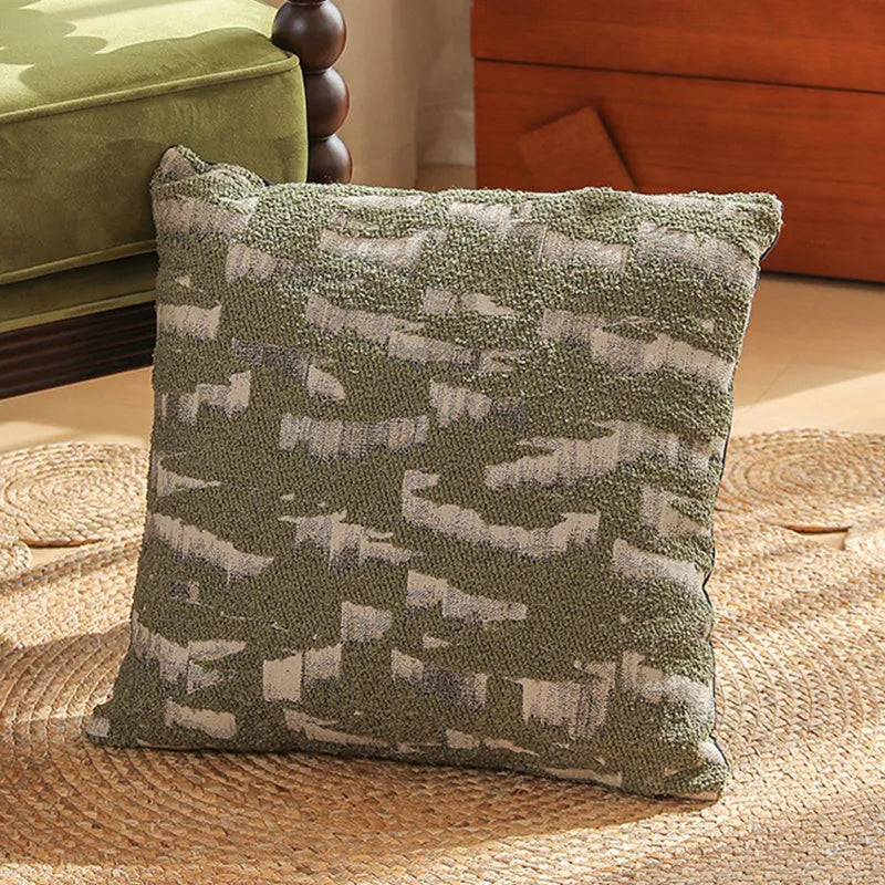 Close-up of a square jacquard pillow cover with a woven retro floral pattern in various colours, sized 45 by 45 cm.