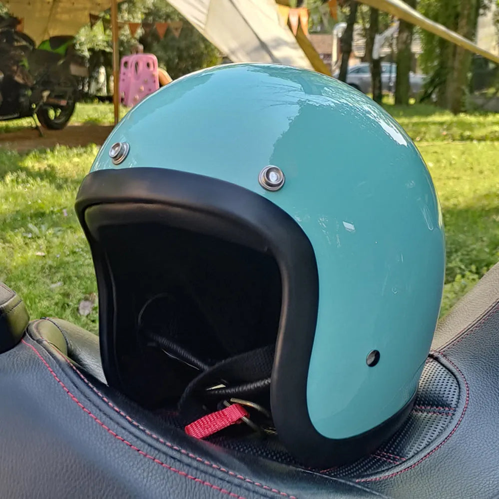 Glass fibre motorcycle half helmet in retro style shown in cement grey colour