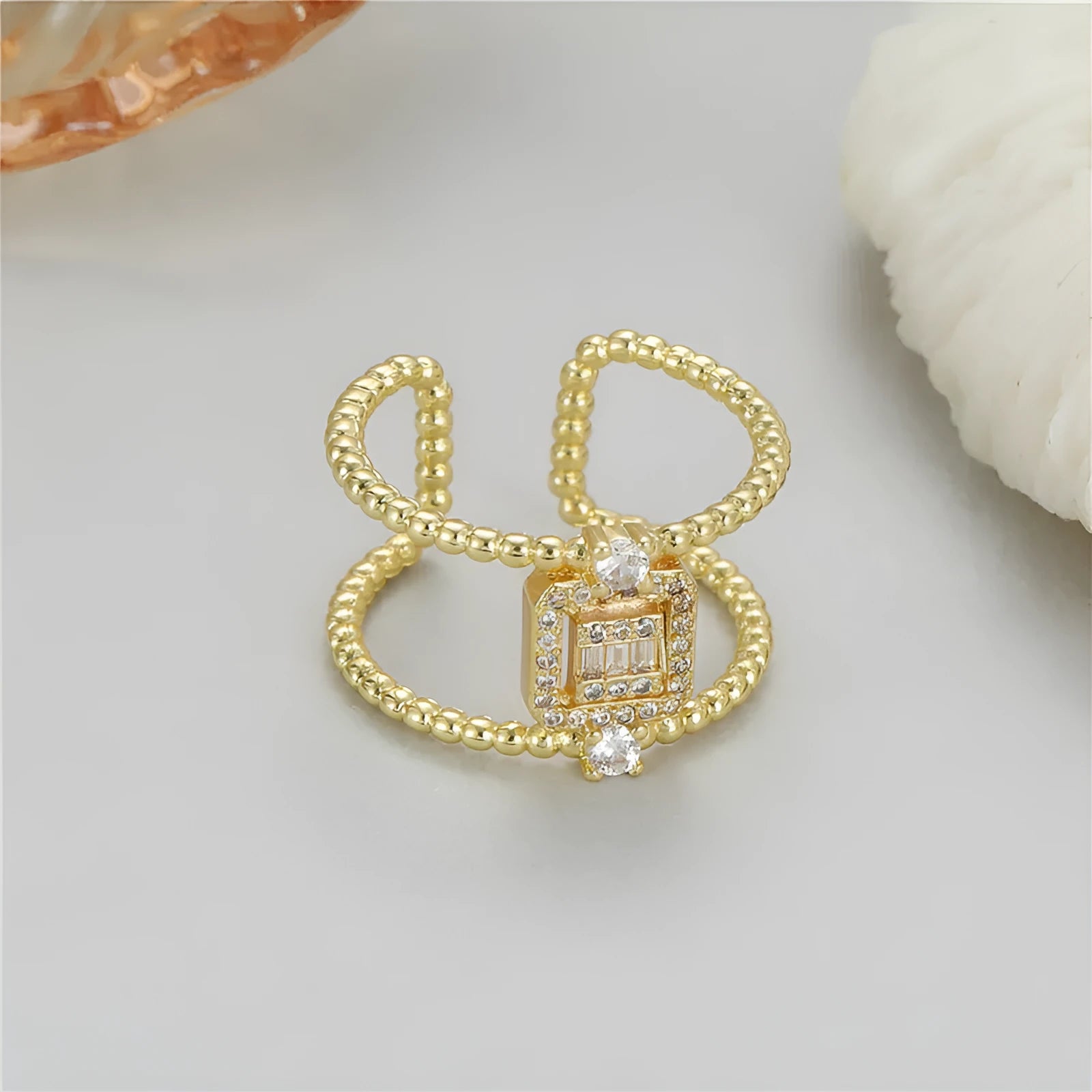 Gold-plated copper open ring with U-shaped asymmetric design and adjustable opening.