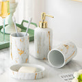 White marble ceramic bathroom wash kit with two cups, latex bottle, and soap box on a counter