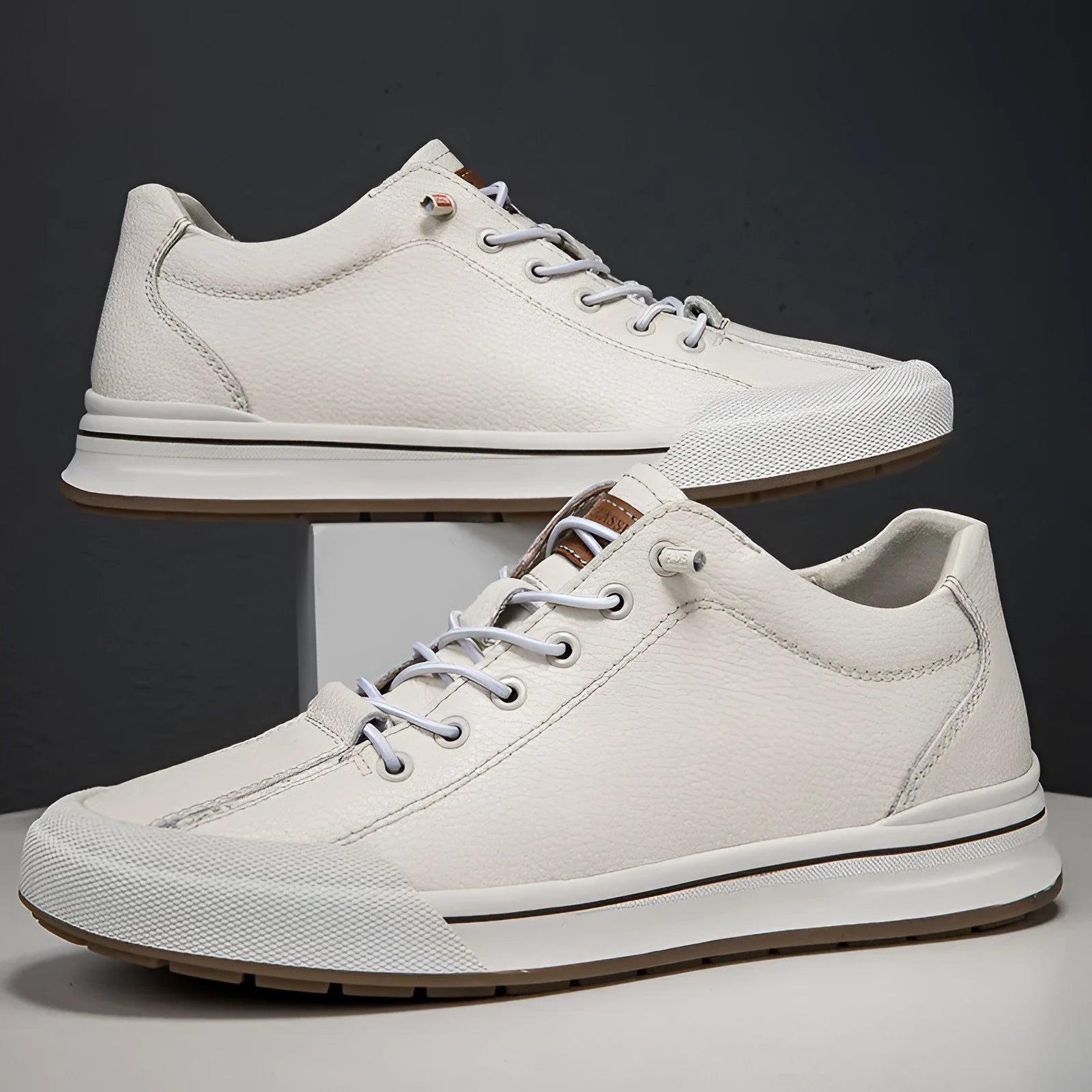 Men's white and black matte leather casual shoes with round toe and flat heel.