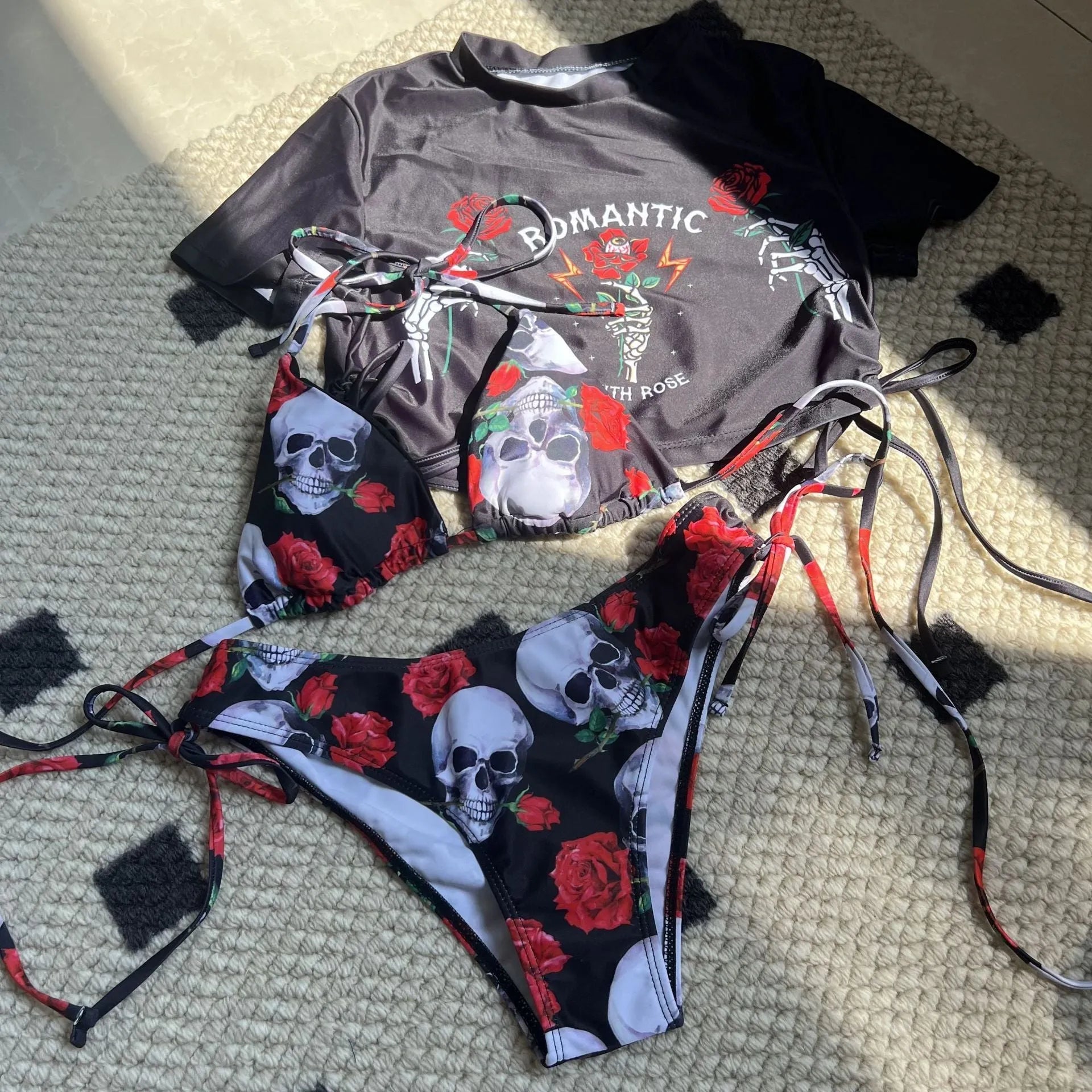 Women wearing a skull rose printed three-piece bikini set in red, polyester fabric, with shorts and top