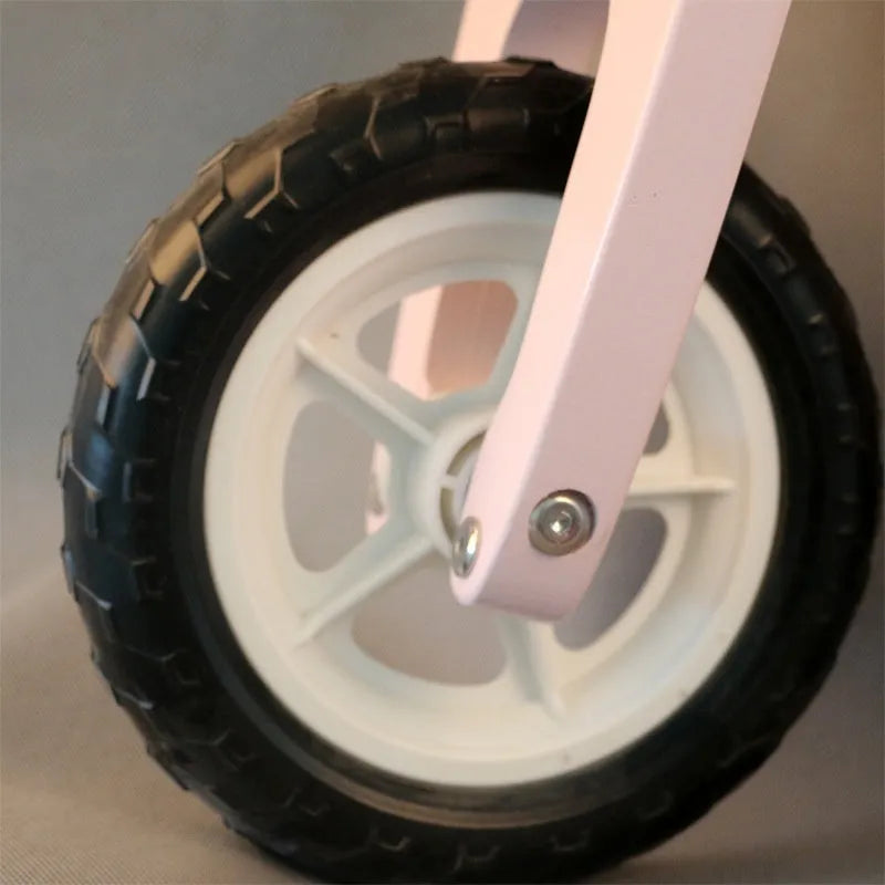 Pink wooden balance scooter with 10-inch wheels for toddlers and young children.