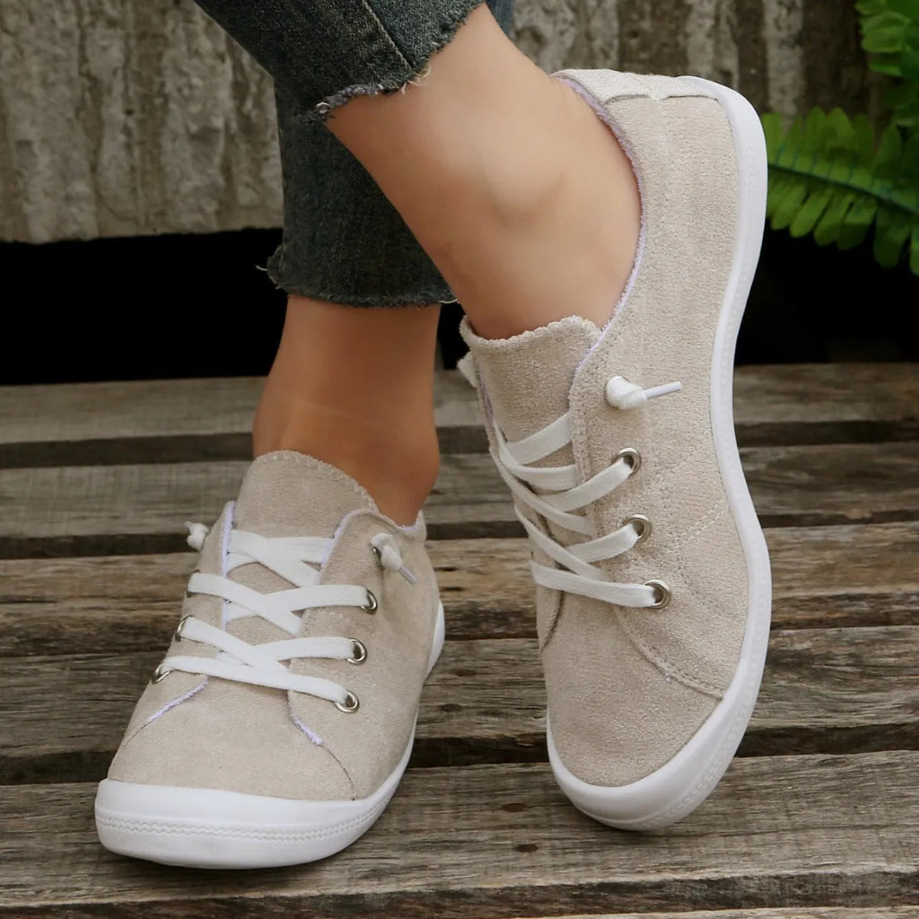 Women's beige casual sneaker with fabric upper and rubber sole on neutral background