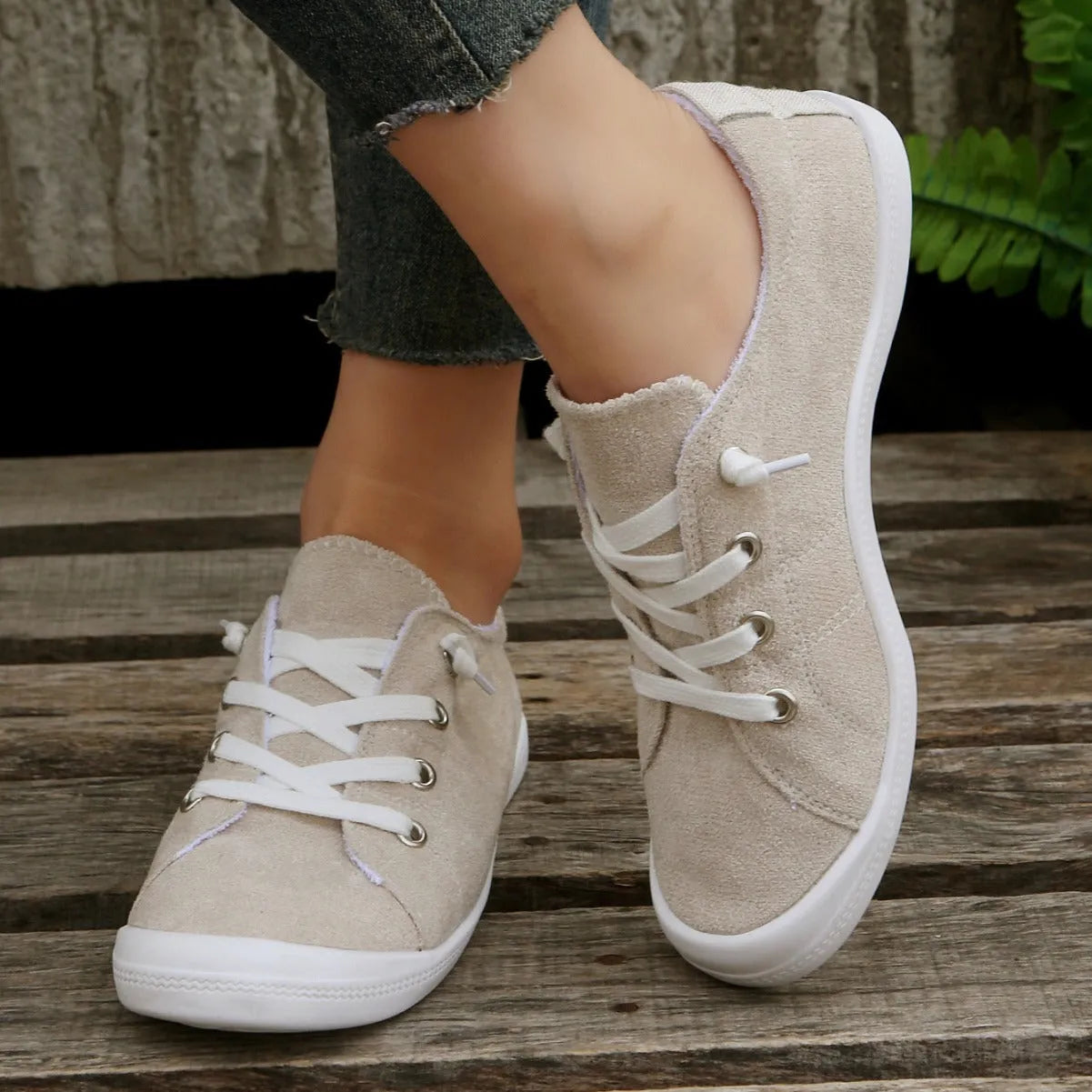 Women's beige casual sneaker with fabric upper and rubber sole on neutral background