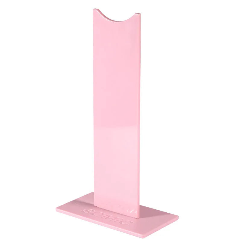 Pink and black detachable headset stand bracket for gaming headphones on a desk