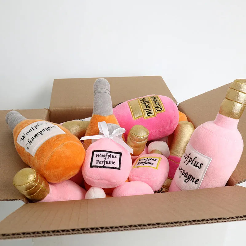 Green plush wine bottle shaped pet toy on a white background