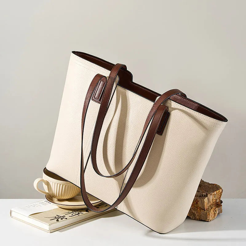 Women's black genuine leather crossbody commuter bag with horizontal square design showing internal organisation compartments
