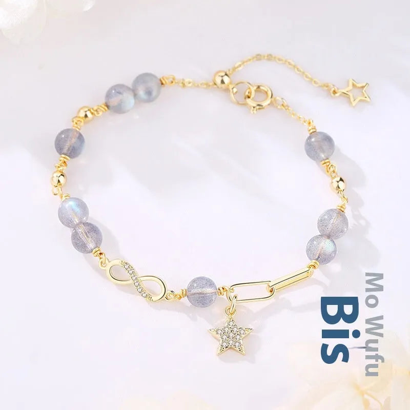 Natural gray moonstone Mobius crystal bracelet with polished finish on women's wrist