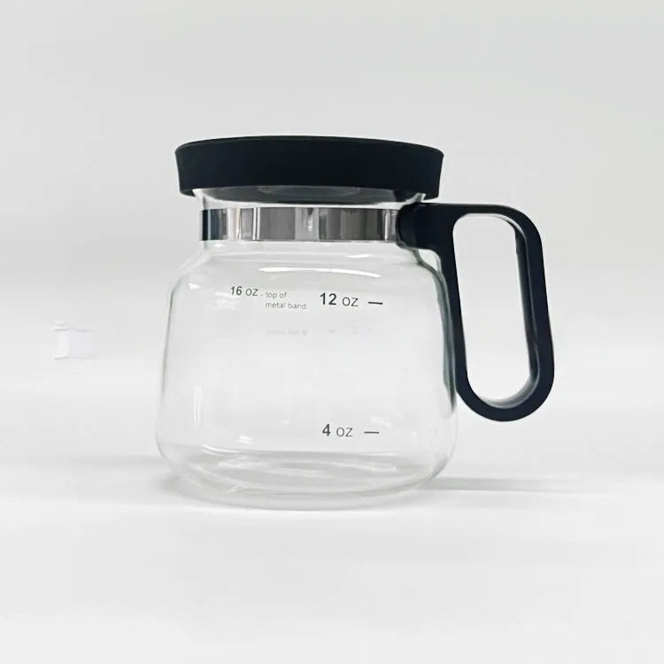 Transparent borosilicate glass coffee maker with black silicone thermal cover on a kitchen counter.
