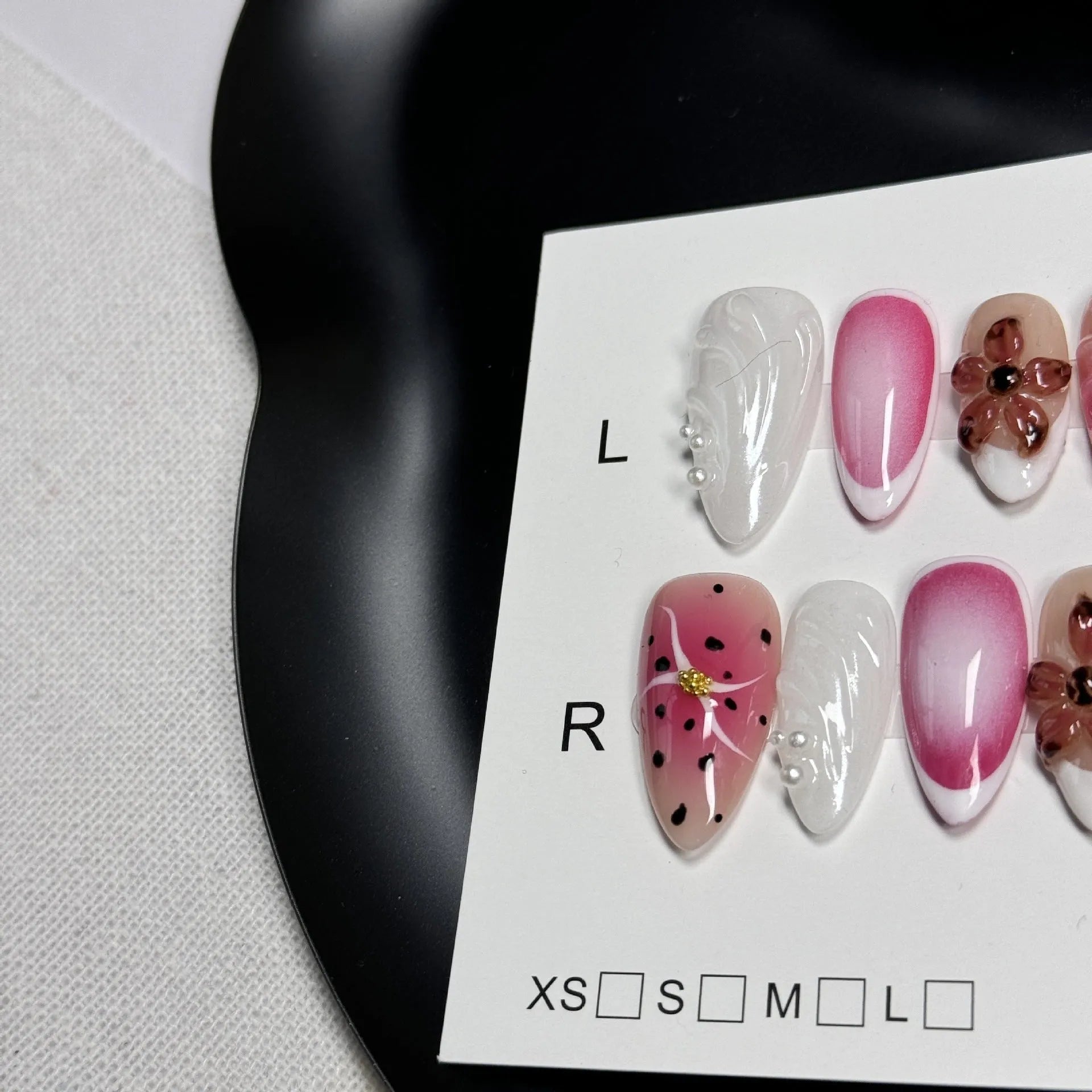 Hand-painted 3D nail patches with embossed candy patterns in almond shape on plastic armour suit