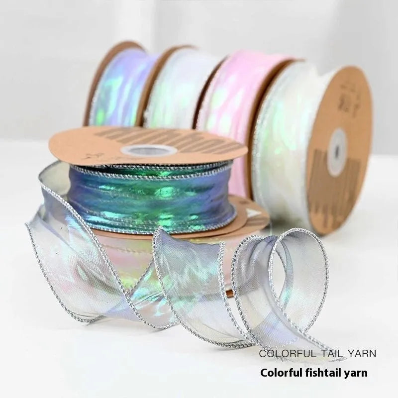 Fishtail yarn mesh ribbon roll in various illusion colours showing wave pattern and 4cm width