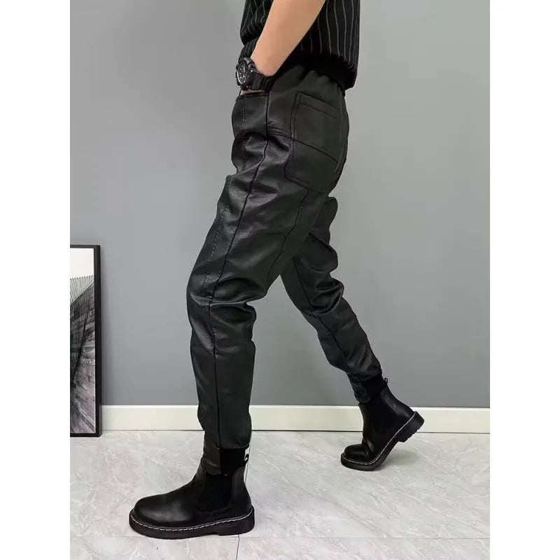 Black PU leather motorcycle takeaway pants with cuffs, tapered leg, and mid-rise waist, on a model