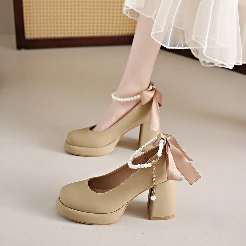 Beige women's Mary Jane shoes with chunky heel, ankle strap buckle, and pearl decoration on round toe
