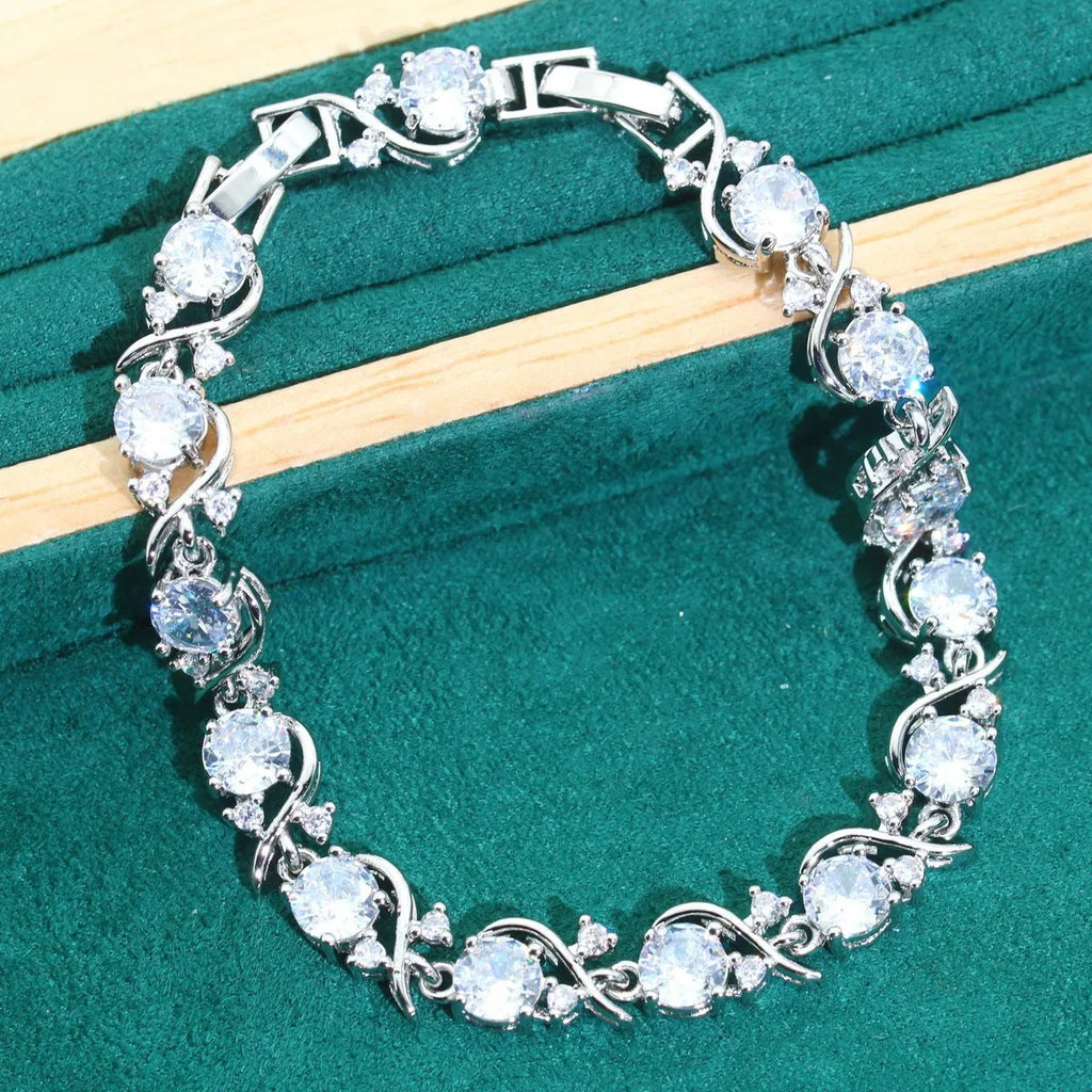 Bridal zircon jewellery four-piece set showing necklace, bracelet, earrings, and ring with water wave chain