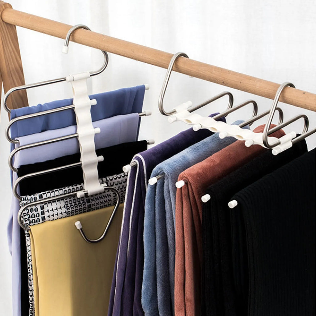 Black 5-in-1 stainless steel trouser hanger with five booms and dual hooks on a clothes rack