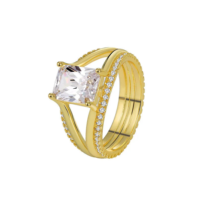 Gold geometric women's ring with a square zircon stone on a hand.