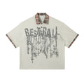 Men's loose blue short-sleeved top with asymmetric lapel and graffiti-style print.