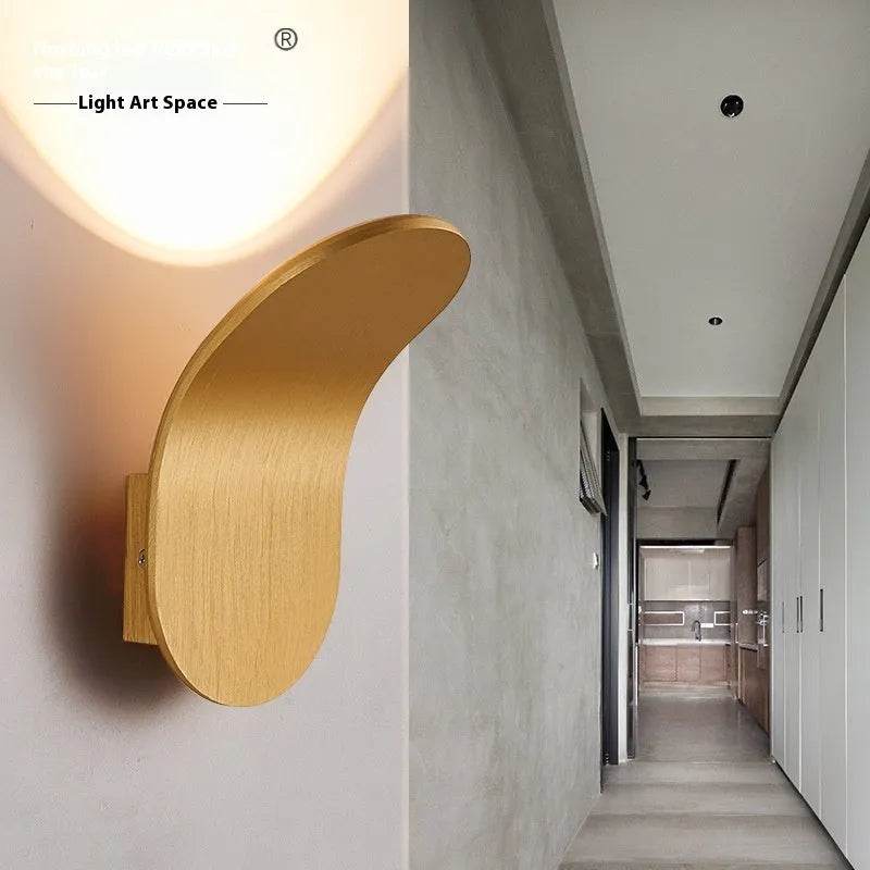 Modern simplicity wall light bulb in brushed black finish against a white wall
