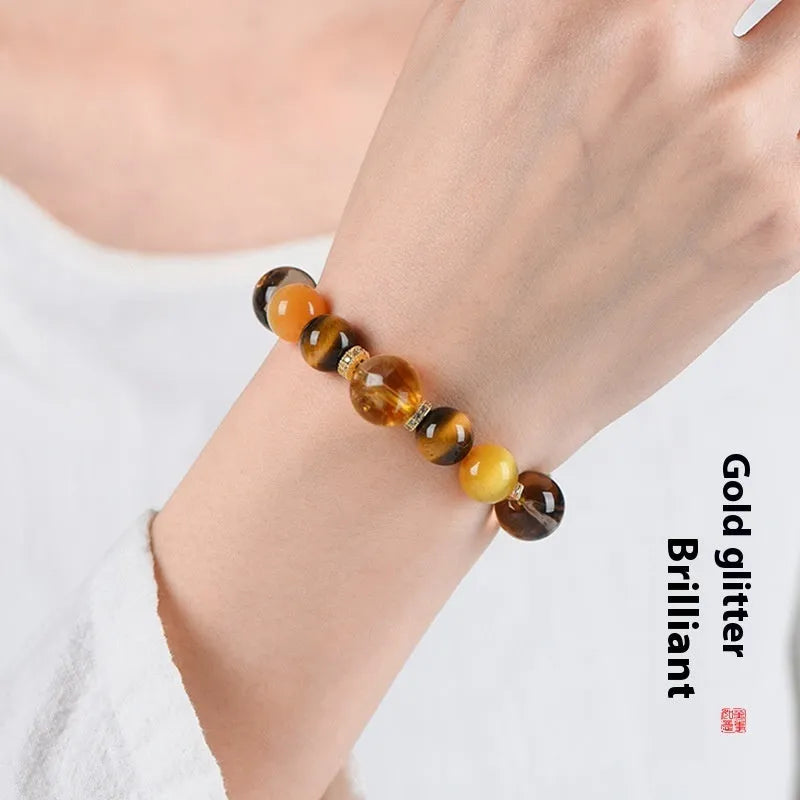 Close-up of a women's bracelet with yellow tower-shaped artificial crystal beads on a string.