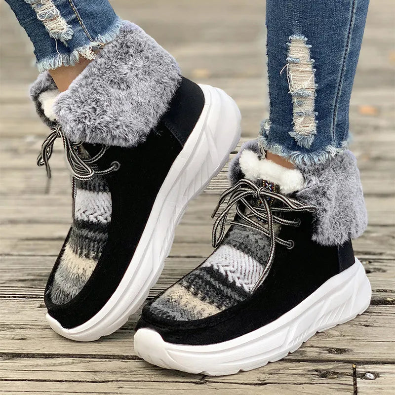 Women's beige suede lace-up snow boots with a thick rubber sole and plush lining on a white background.