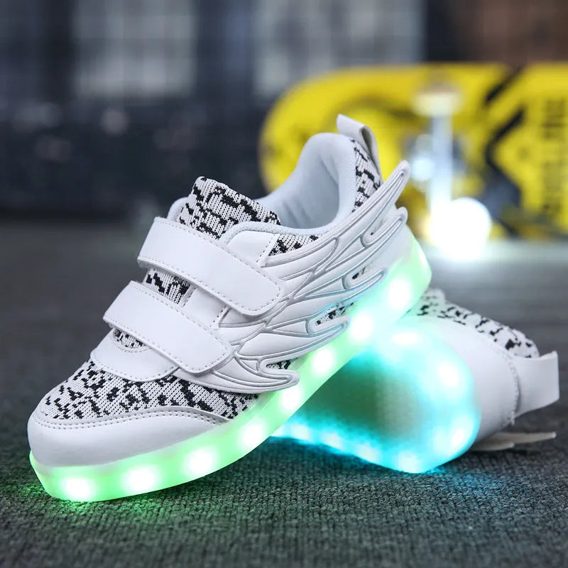 Children's plum red and white LED light up sneakers showing USB charging port and lights illuminated.