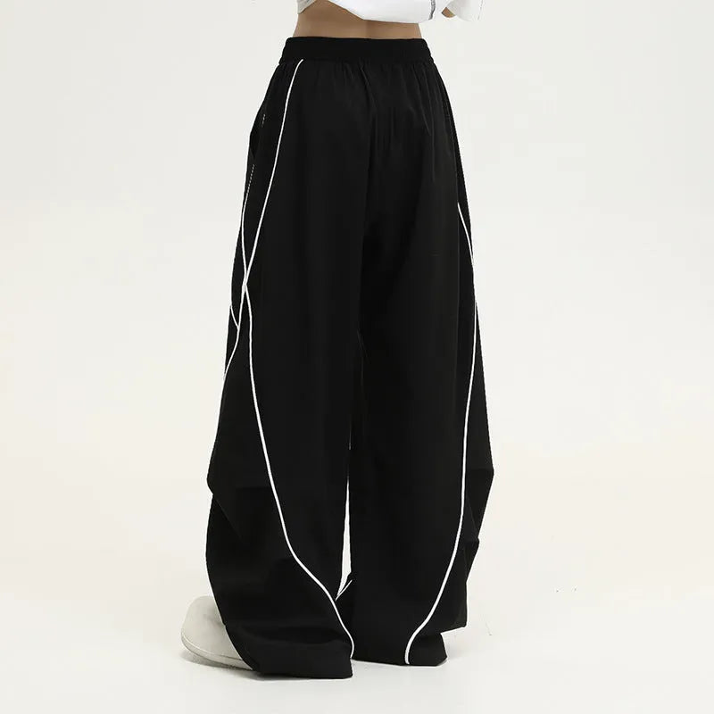 Black pleated wide-leg hip hop sports trousers with a striped pattern.