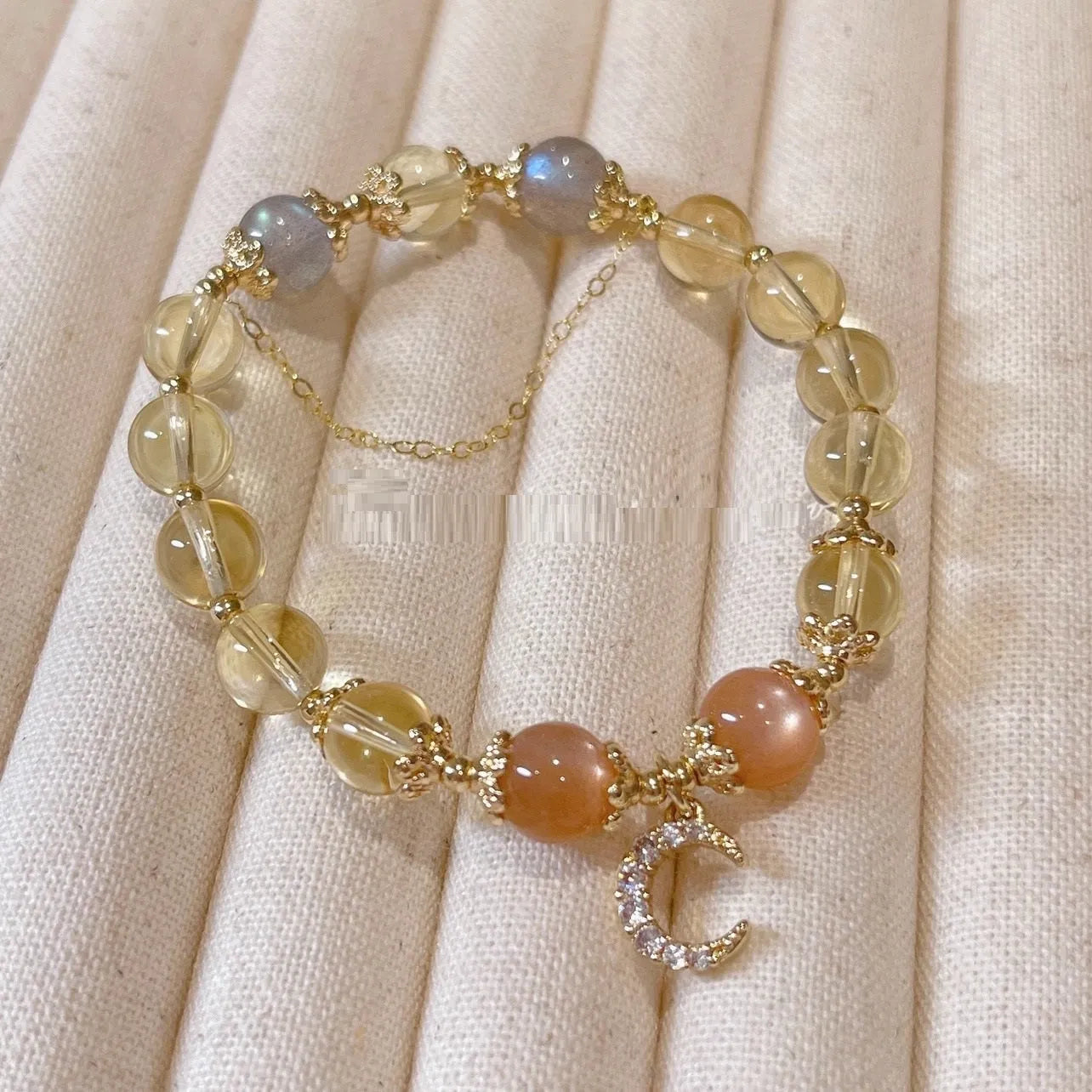 Chinese style crystal bracelet with 14K gold electroplating and citrine moonstone beads in diamond shapes