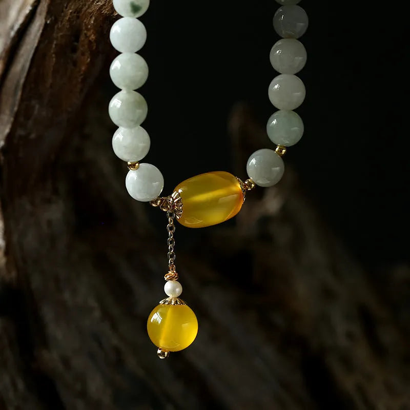 Women's bracelet with 7.5mm round agate beads and hanging tassel in 14K gilded finish