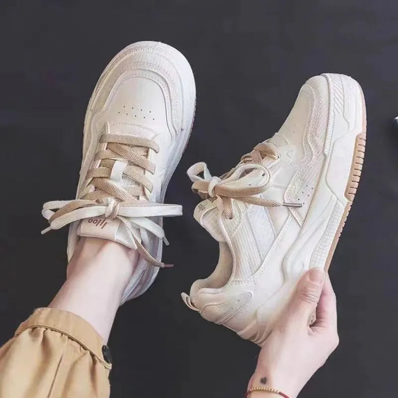 Women's pink low top sneaker with a rubber platform sole on a white background.