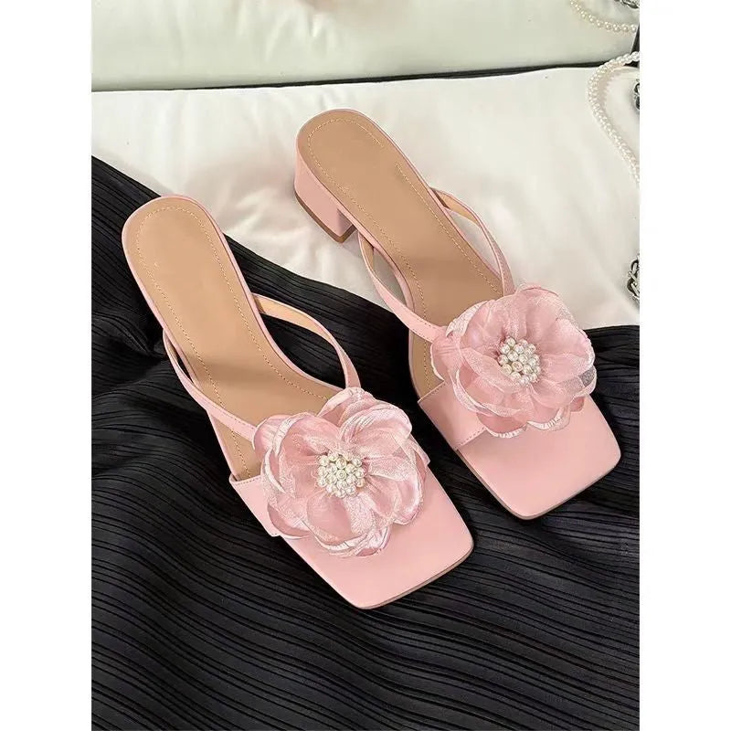 Women's chunky heel sandals with square toe, satin upper, and floral detail in cream-white.