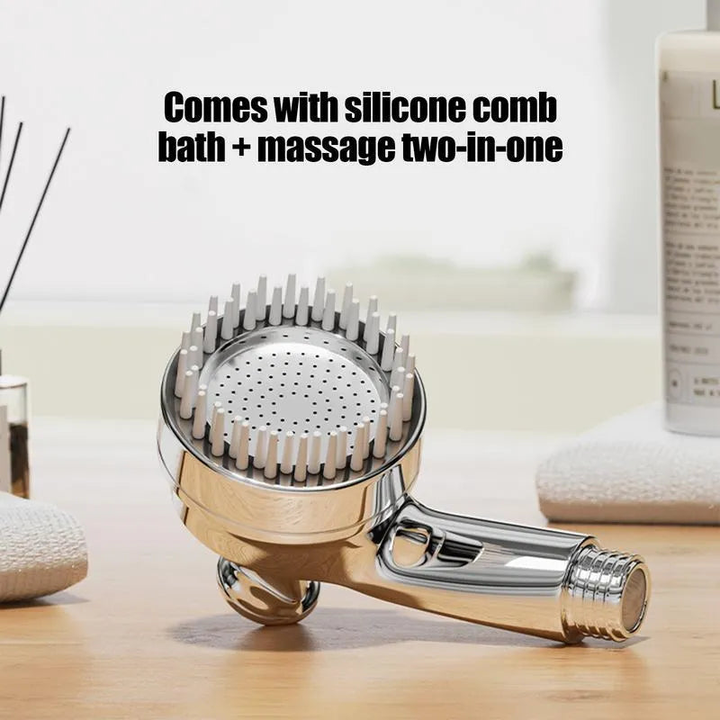 Silver dog shower attachment with soft silicone comb teeth and ergonomic grip on a white background