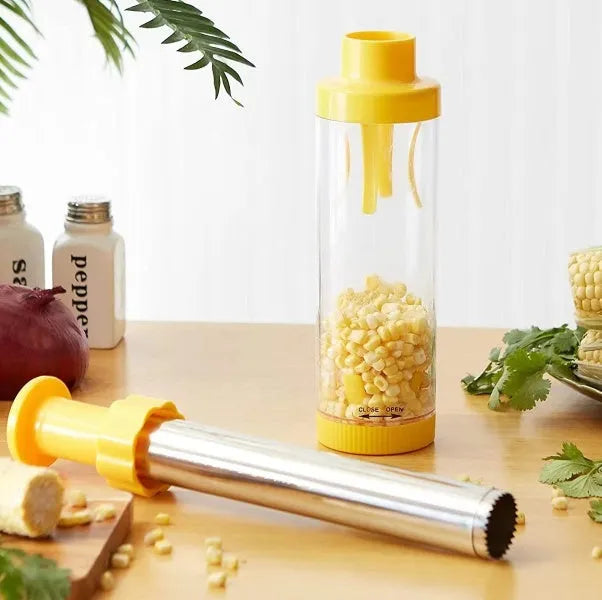 Yellow manual corn stripper with cylindrical ABS plastic body and stainless steel cutting surface on white background