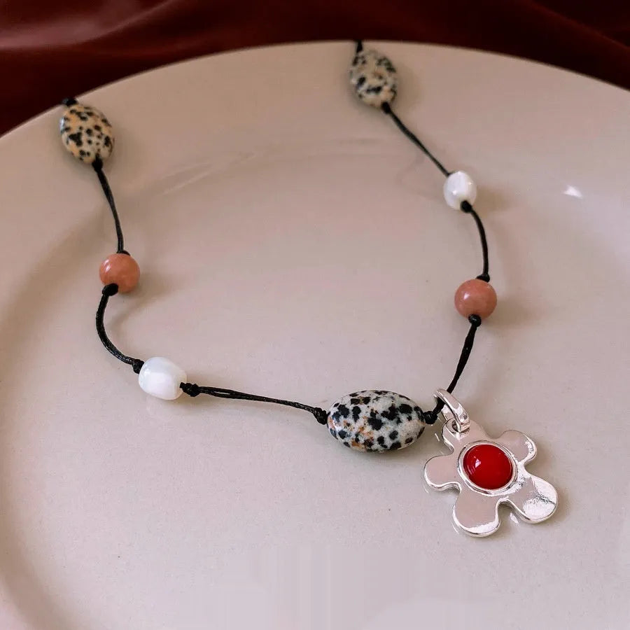Stone shell beaded flower pendant necklace on alloy clavicle chain with electroplated finish in silver and gold tones