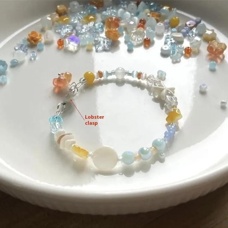 Orange seaside bracelet for women with diamond-shaped charm and round decorative elements on mixed material band