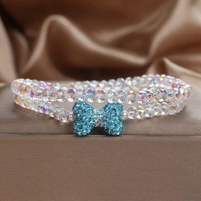 Double ring crystal bracelet with pearl and rhinestone accents on light background