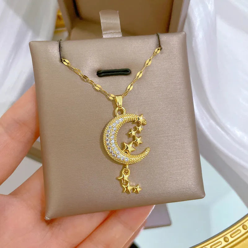 Geometric moon pendant necklace with tassel detailing in stainless steel and copper construction