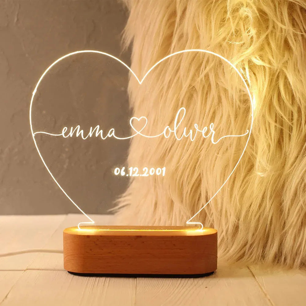 Custom acrylic LED night light displaying engraved names and dates on clear 20cm by 11.5cm panel