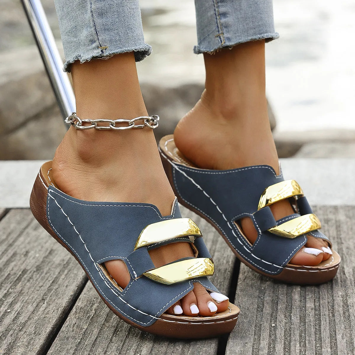 Women's Roman style platform sandals in black, showing strapped design and flat rubber sole.