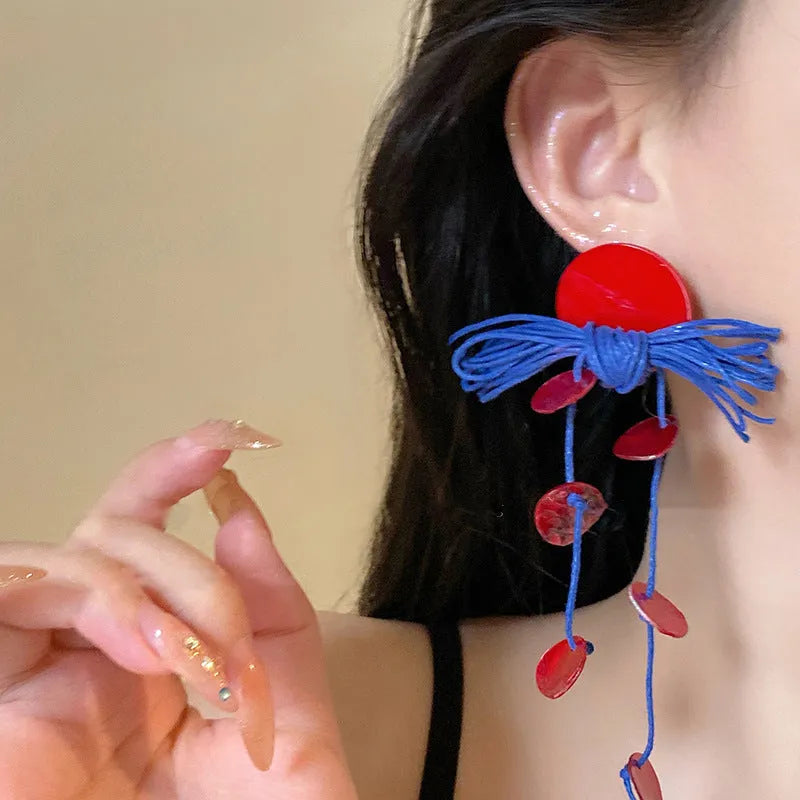 Women's geometric earrings with blue resin flowers on fabric in silver needle colour with circular design elements