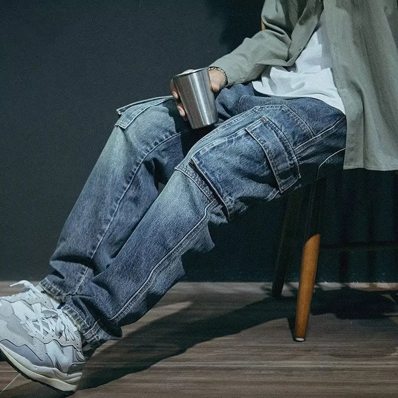 Man wearing blue loose straight-leg denim jeans with a zip fly, casual style.