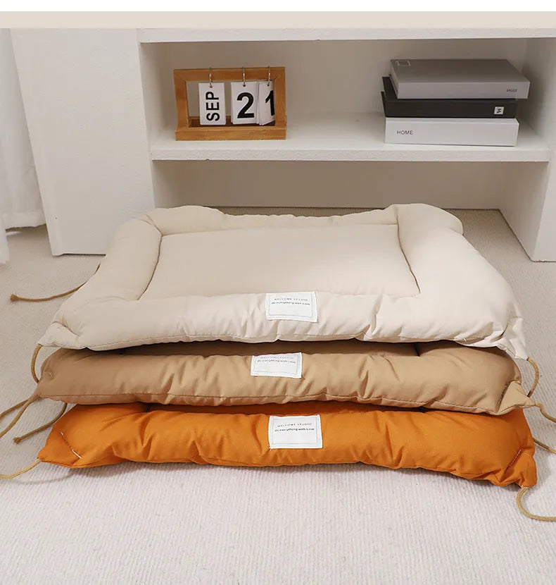 Beige cage cushion tied in a wire dog crate with soft padding for small pets