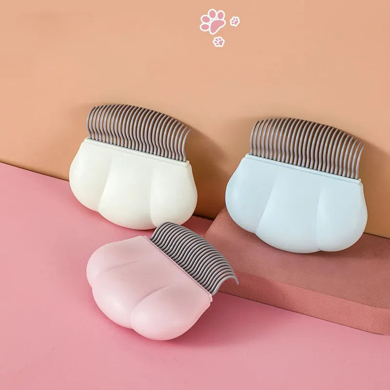 Paw Soft deshedding grooming brush for cats and dogs in blue, pink, or white