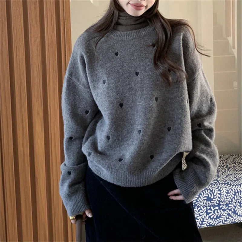 Women's loose-fit acrylic pullover sweater with embroidered love pattern in milky white.