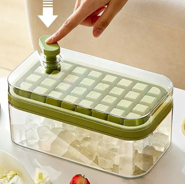One-touch press ice cube maker mould box with green lid, ice cubes, and shovel on white background