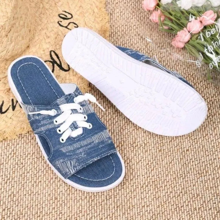 Blue women's canvas slippers in Roman style with a flat design and rubber sole